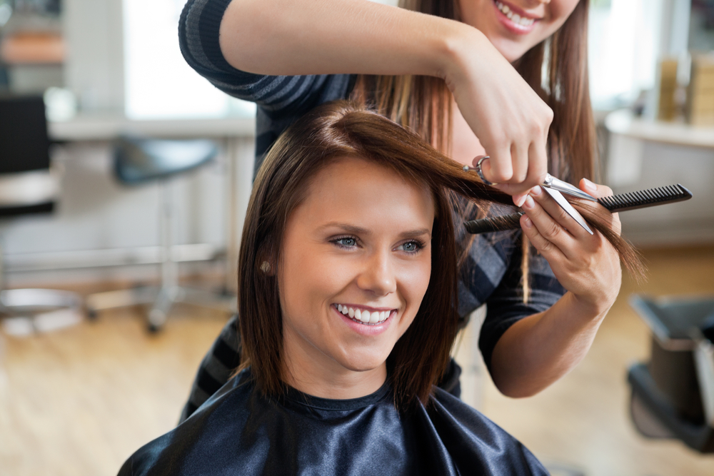 woman getting hair cut in salon