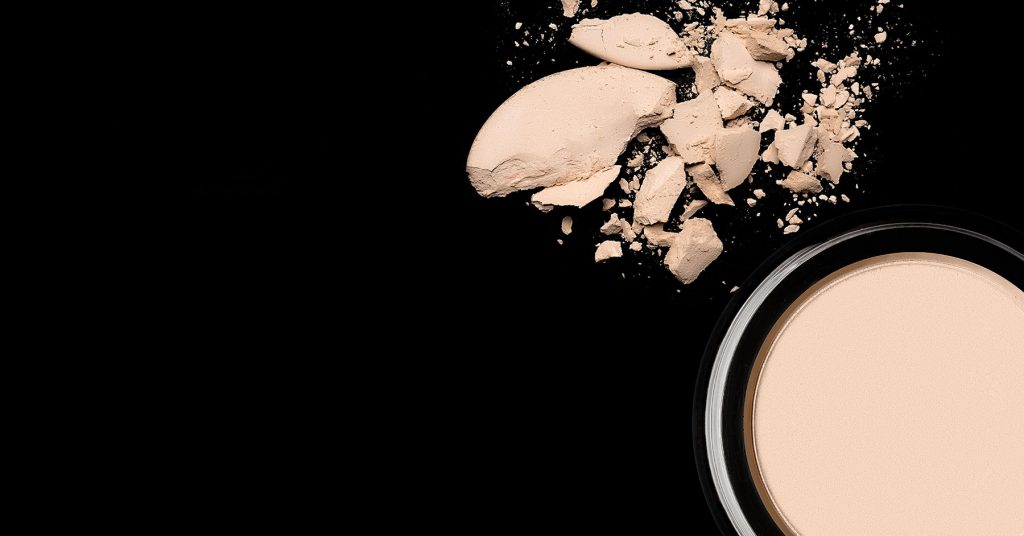 makeup foundation powder on black background