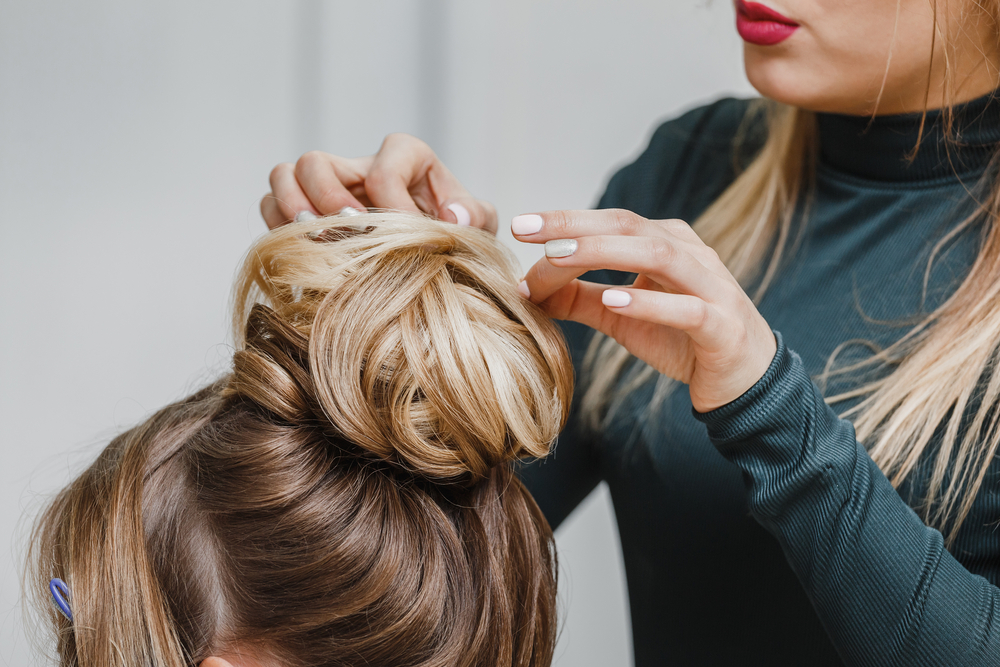 cosmetologist working on client's hair