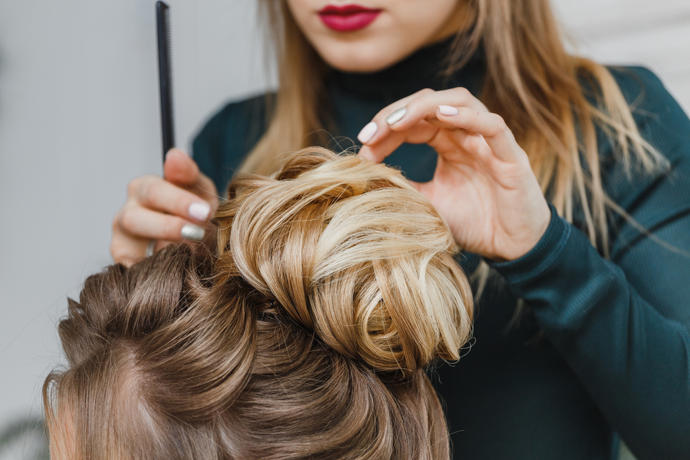 hairstylist fixing client's hair