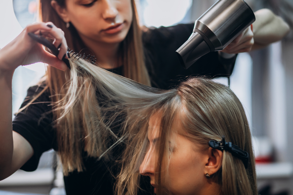 hairstylist helping client with hair