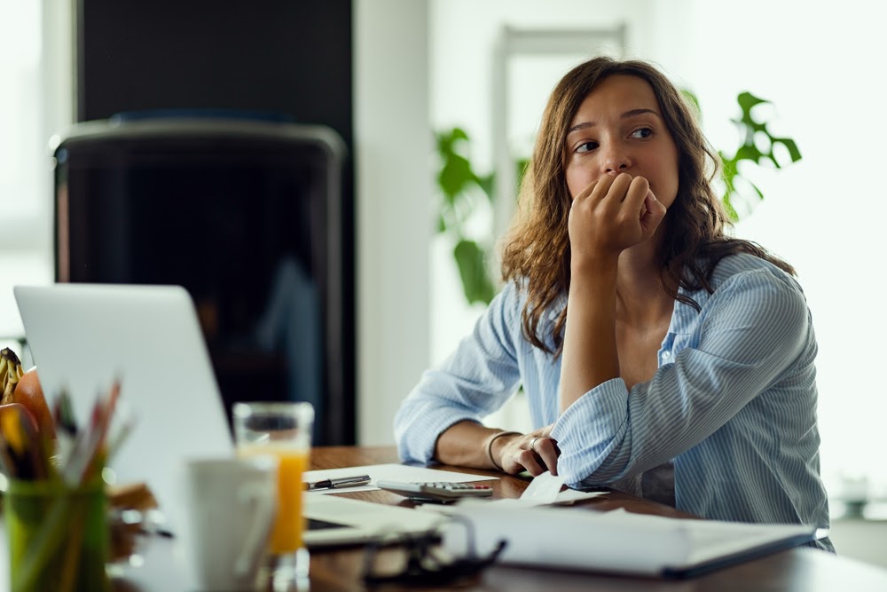 Woman thinking at the computer.